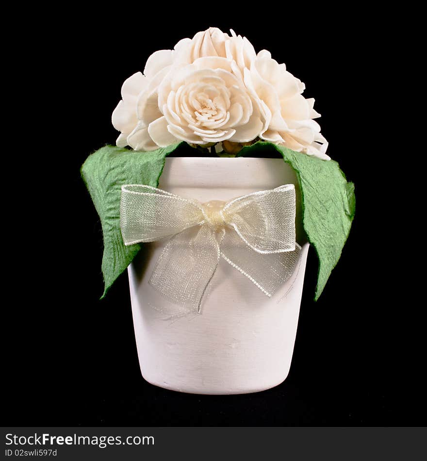 Gift,jasmine and flowerpot on black background