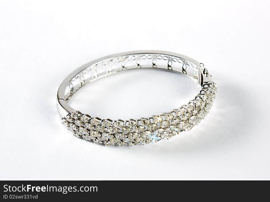 Diamond bracelet with many stones on reflective background