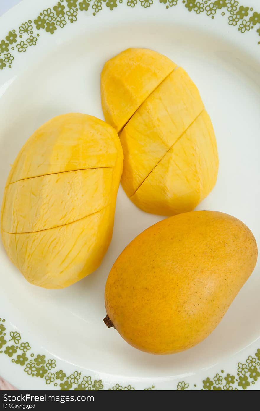 Ripe golden mangoes on white dish,delicious of tropical fruit