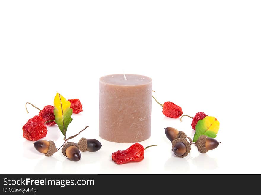 Nature decoration around a brown candle isolated on white background. Nature decoration around a brown candle isolated on white background