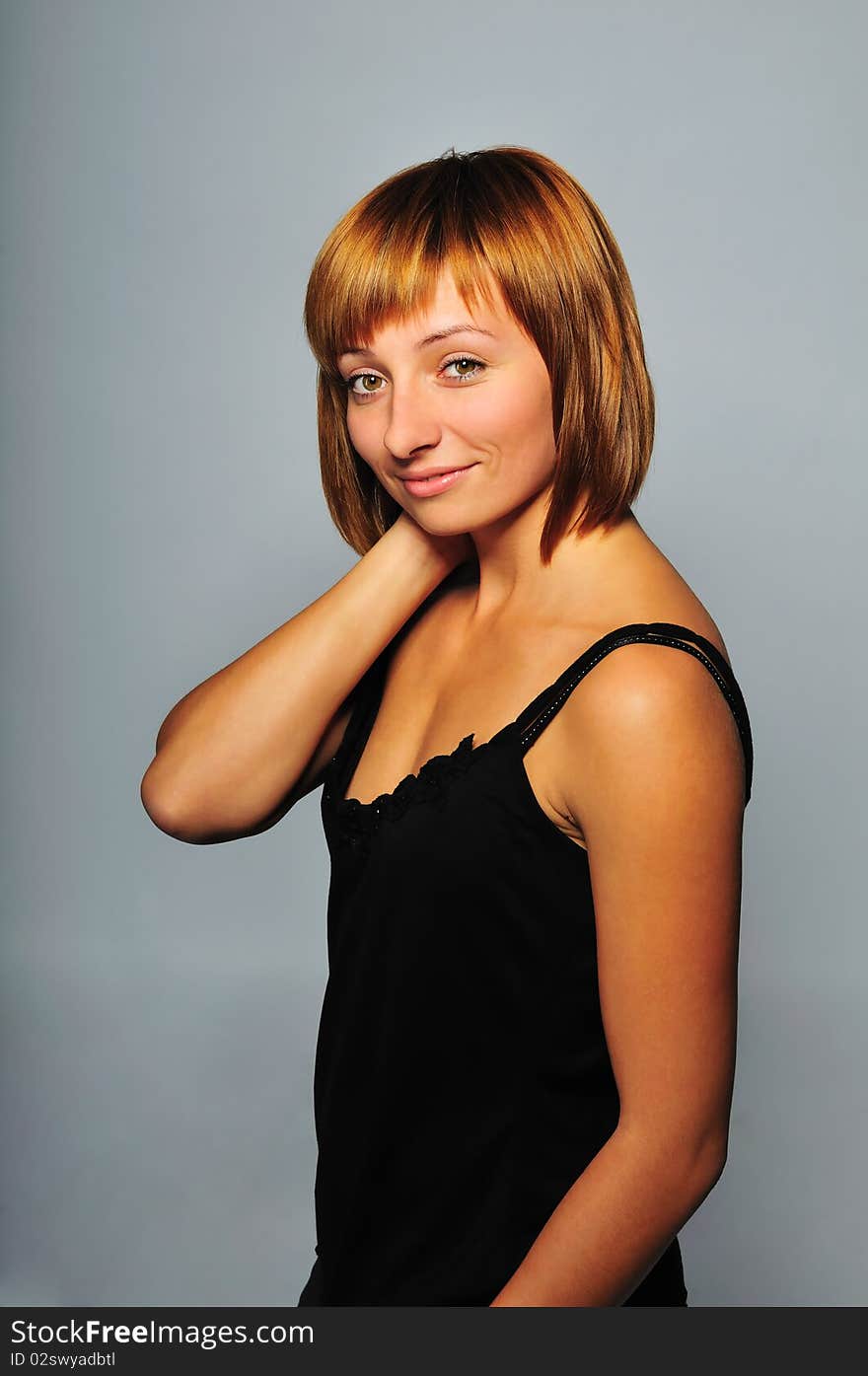 Young women's portrait on the gray background