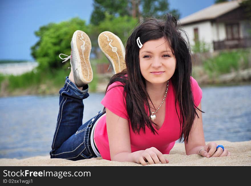 Girl Liyng on the beach