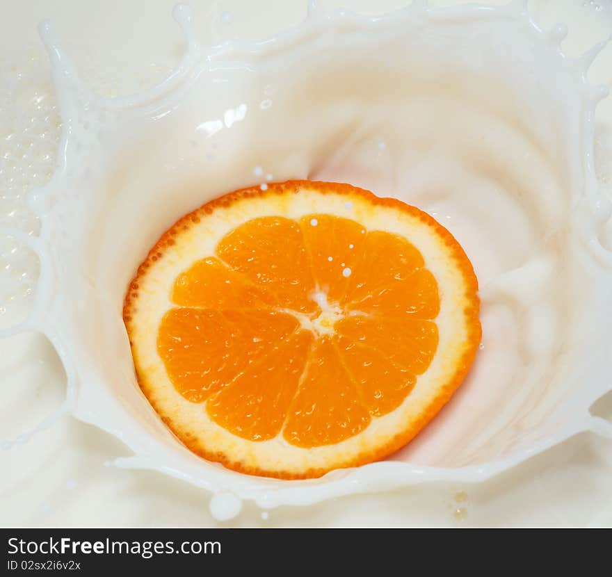 Orange splash in white milk