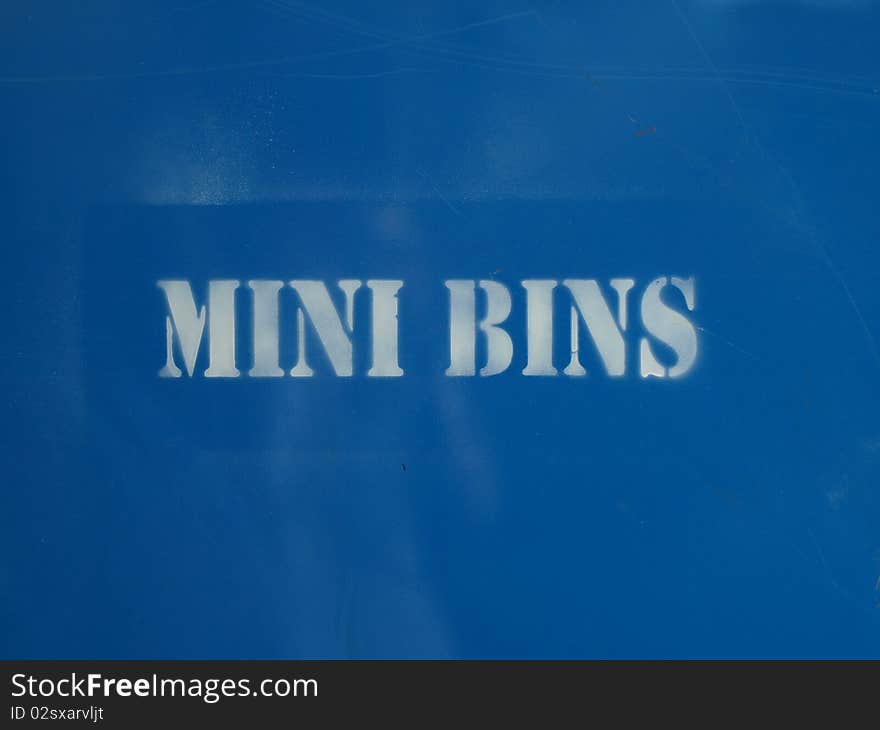 Spray painted Mini Bins offering a contruction style dumpster bin in blue.