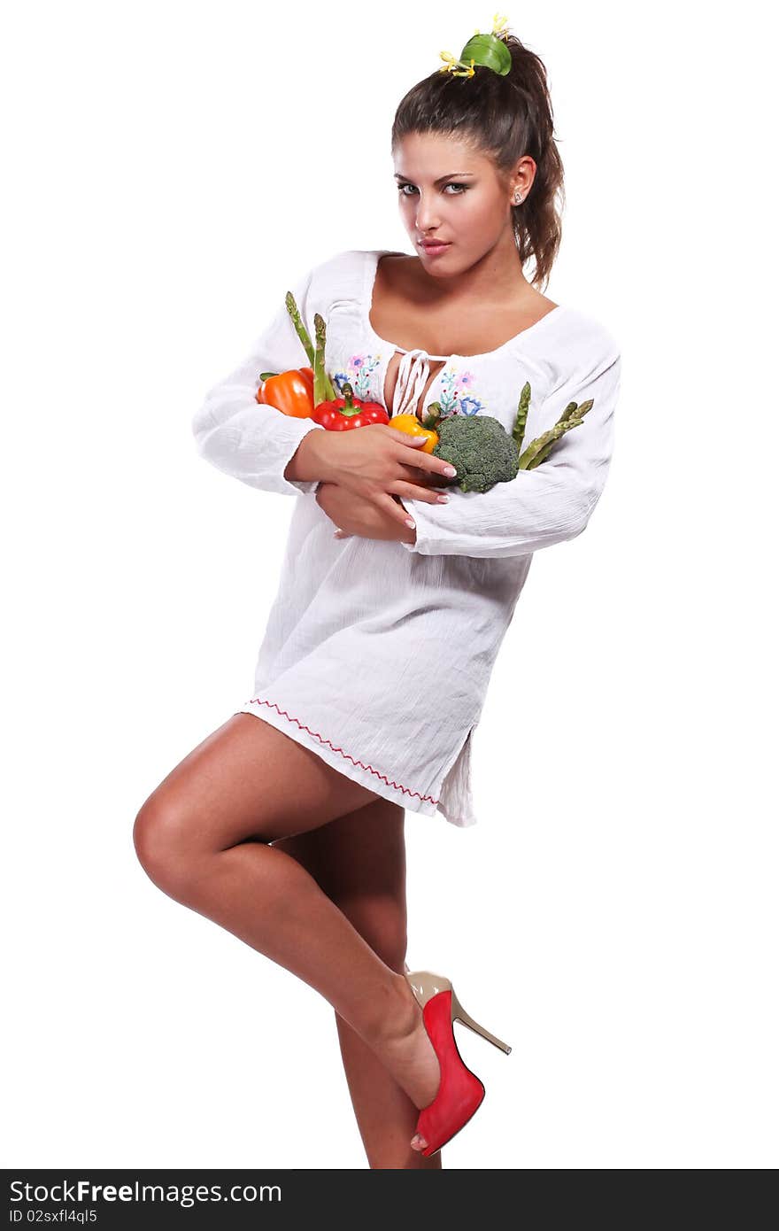 Young beautiful woman with fresh vegetables in her hands. Young beautiful woman with fresh vegetables in her hands