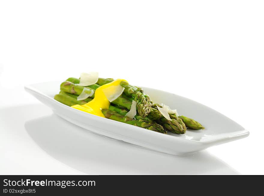 Steamed asparagus topped with hollandaise sauce and parmesan. Steamed asparagus topped with hollandaise sauce and parmesan