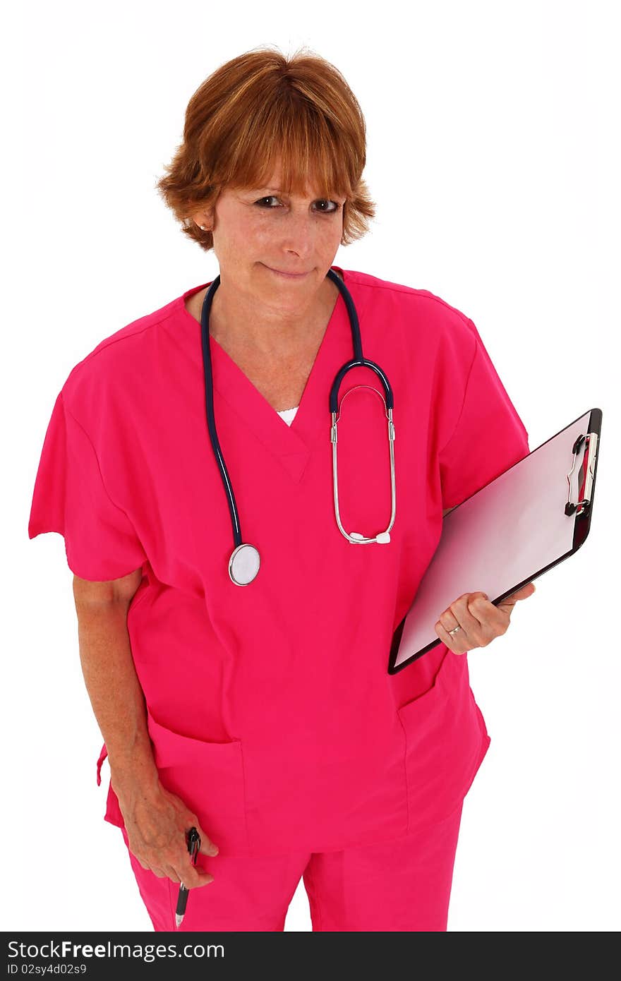 Nurse In Her 50's Looking Up Holding Clipboard. Nurse In Her 50's Looking Up Holding Clipboard