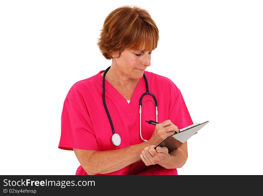 Nurse In Her 50's Writing On Clipboard. Nurse In Her 50's Writing On Clipboard