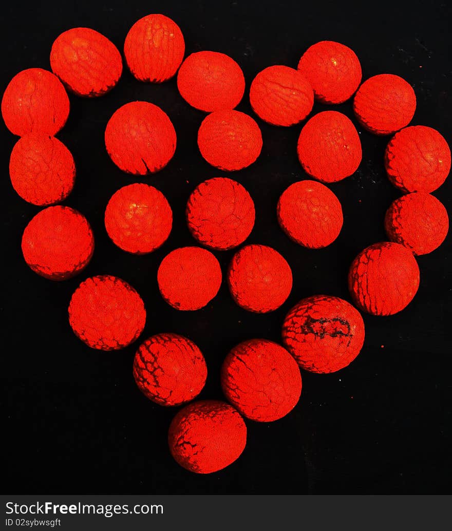 A background of a blood red heart prepared out of red textured balls. A background of a blood red heart prepared out of red textured balls