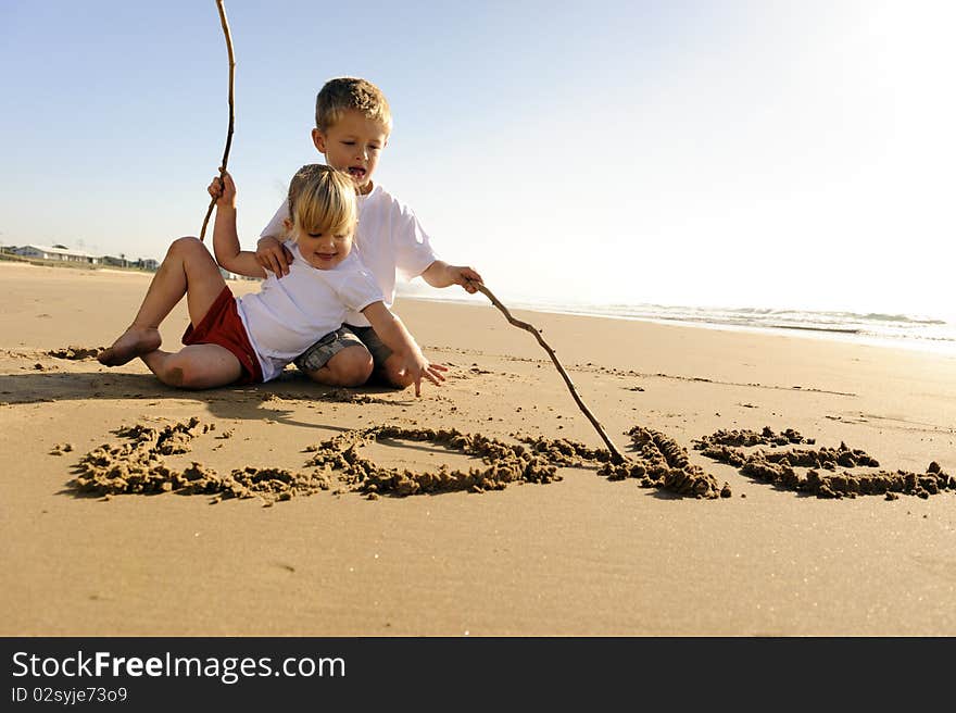 Kids writing in sand