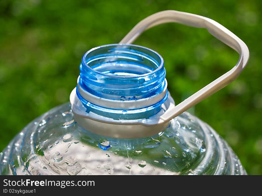 Big open plastic bottle on green background