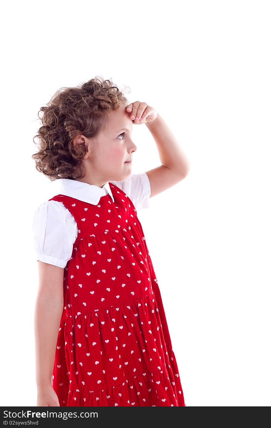 Thoughtful little girl looking forward, with her hand at her forehead