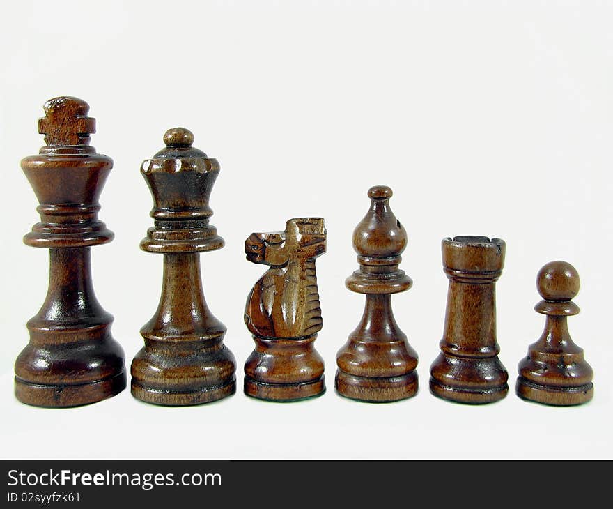 Close up photo of wooden chess pieces, isolated on white background