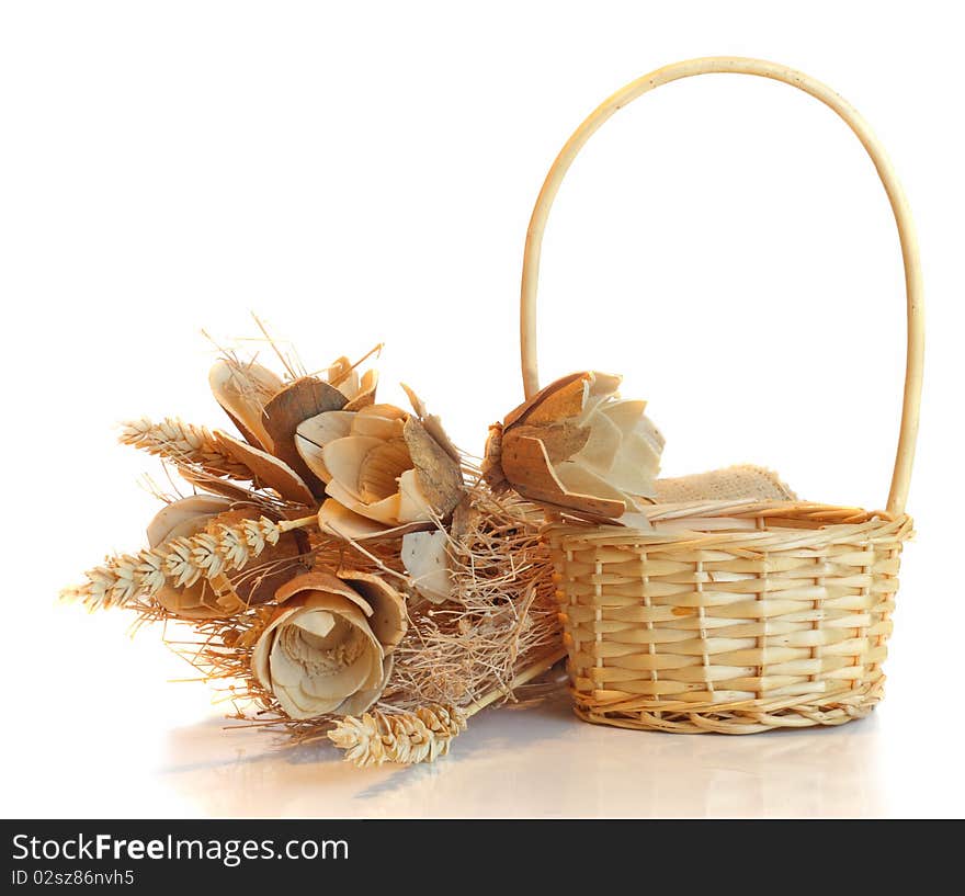 Straw basket and flowers, on white.