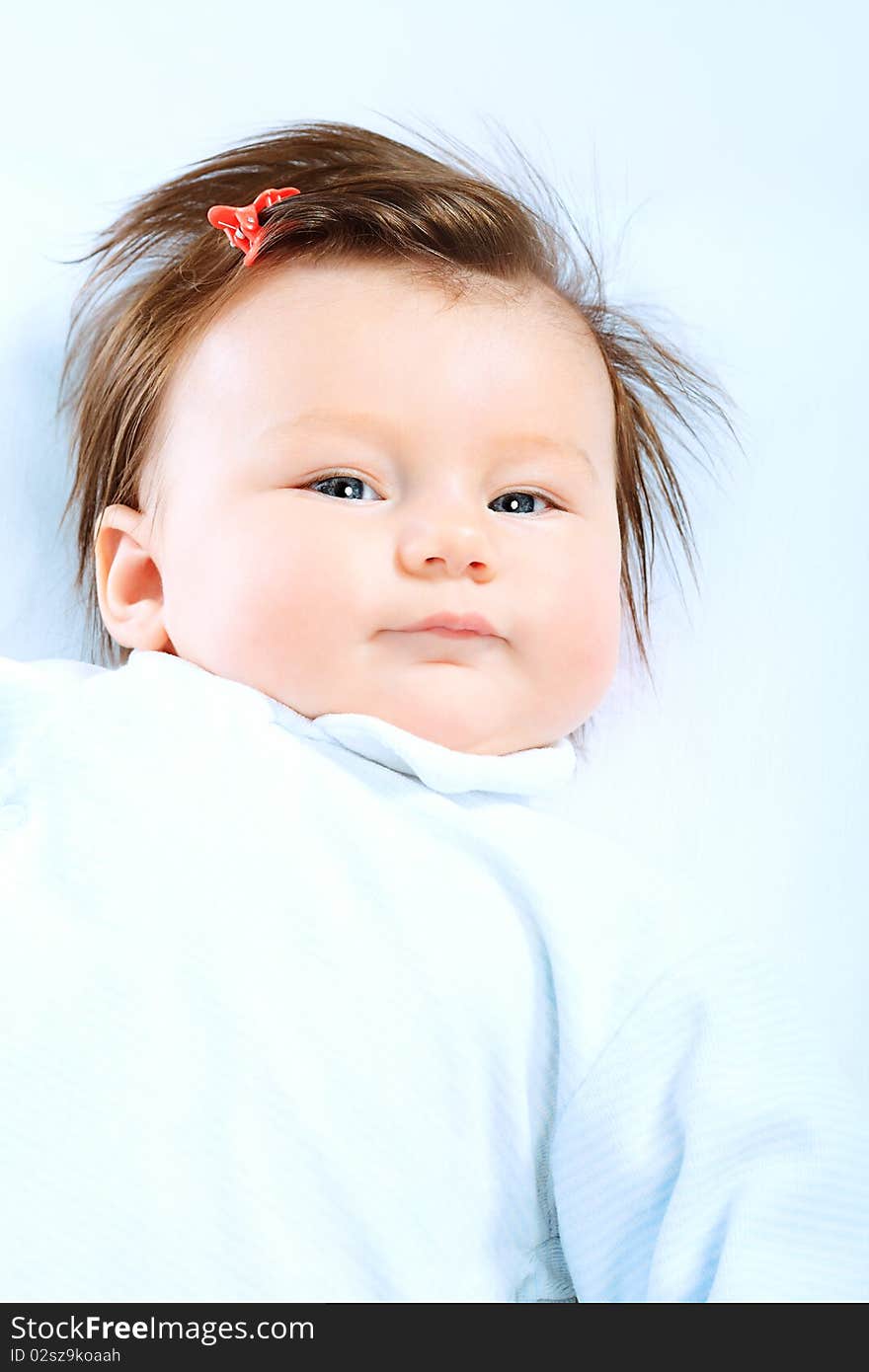 Portrait of a cute baby lying on a white towel. Portrait of a cute baby lying on a white towel.