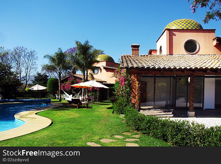 Hotel with swimming pool and palms in the garden. Hotel with swimming pool and palms in the garden