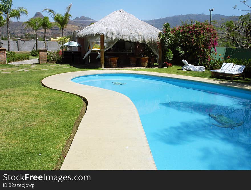 Hotel with swimming pool and palms in the garden. Hotel with swimming pool and palms in the garden