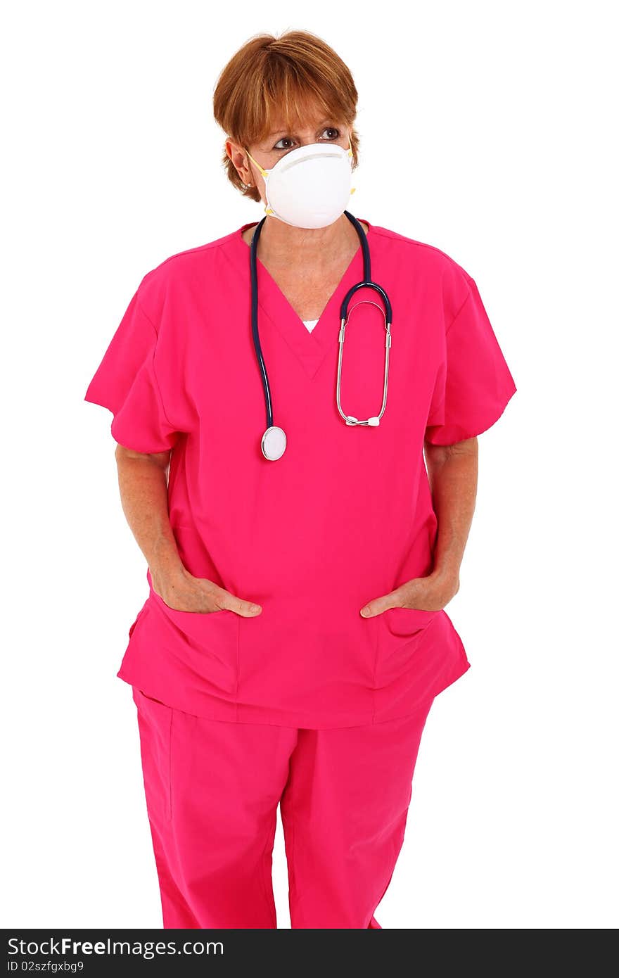 Nurse In Her 50's With Mask Looking To The Side. Nurse In Her 50's With Mask Looking To The Side