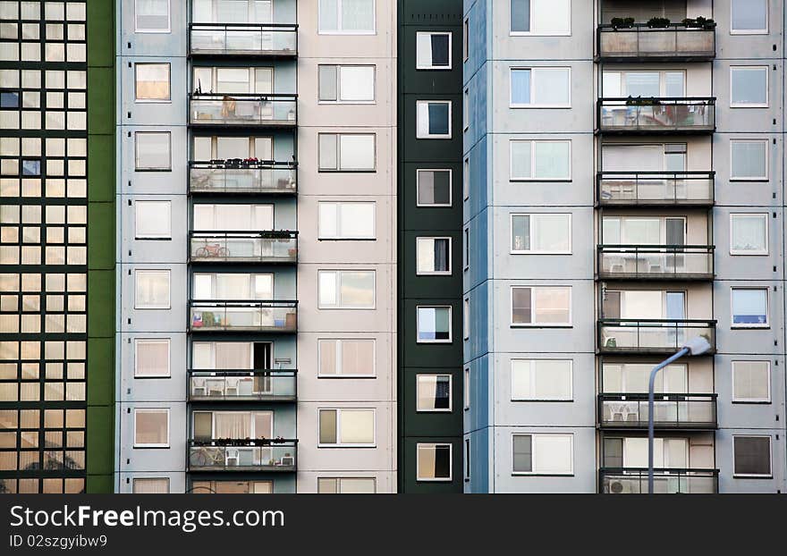 Green and grey prefab house with many balcons and windows. Green and grey prefab house with many balcons and windows