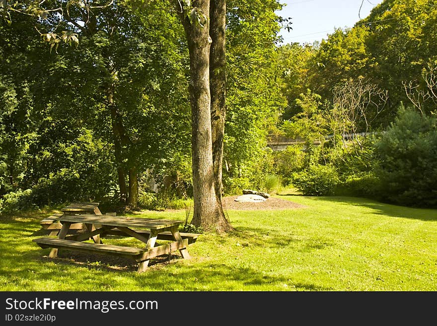 Two picnic tables in park-like setting.