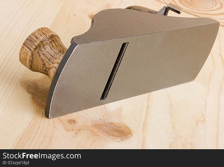 Woodworking handplane on a piece of wood.