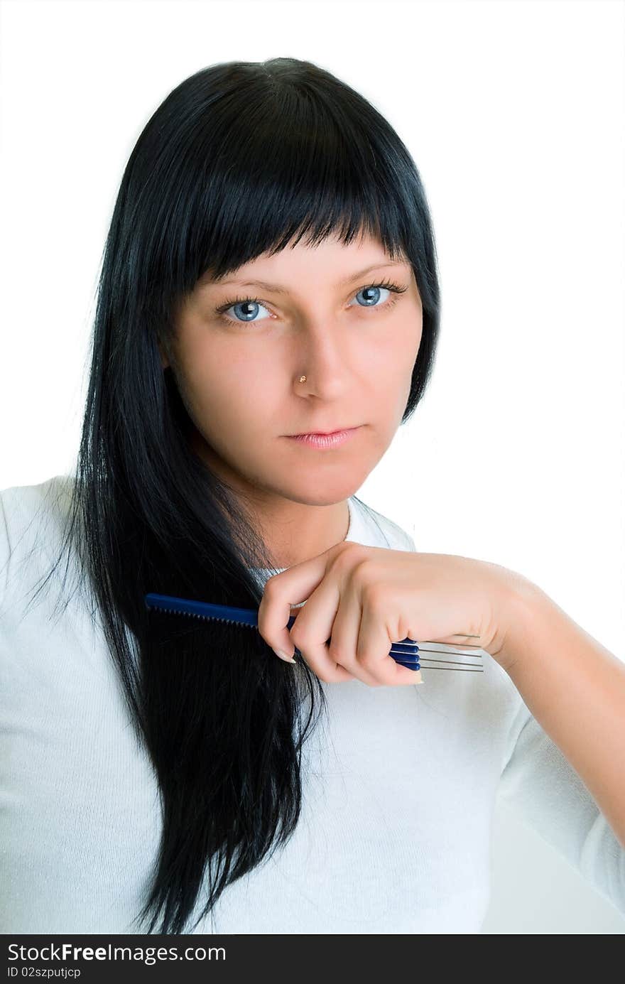 Photo of a girl with blue eyes, which combs hair comb. Isolated on white