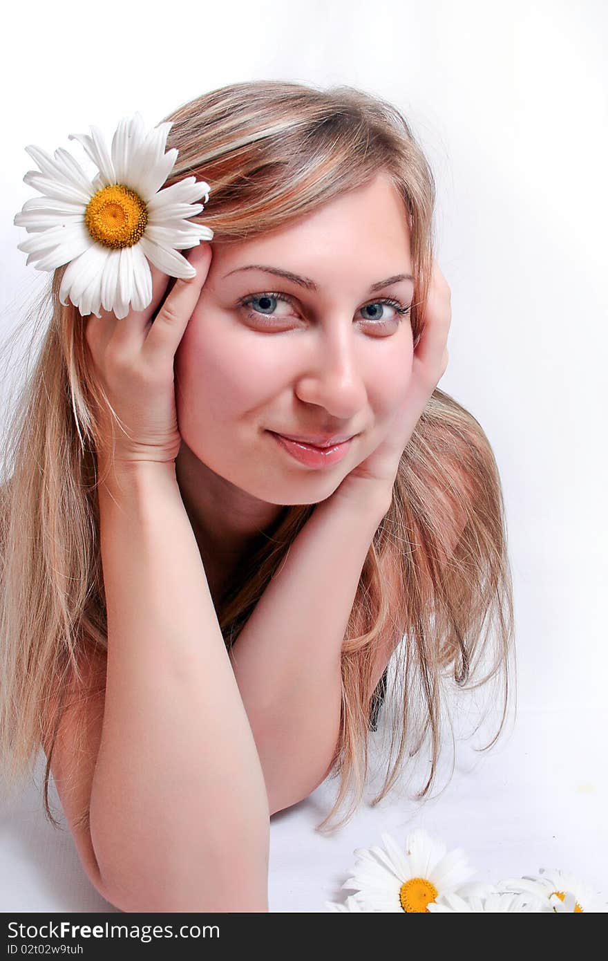 Beautiful woman with chamomile