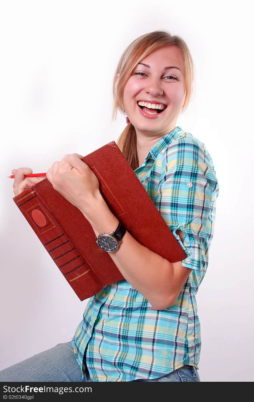 Studying happy young woman reading her book for school