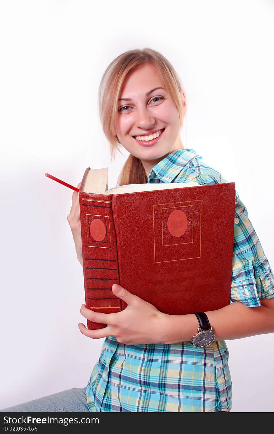 Studying happy young woman reading her book for school. Studying happy young woman reading her book for school