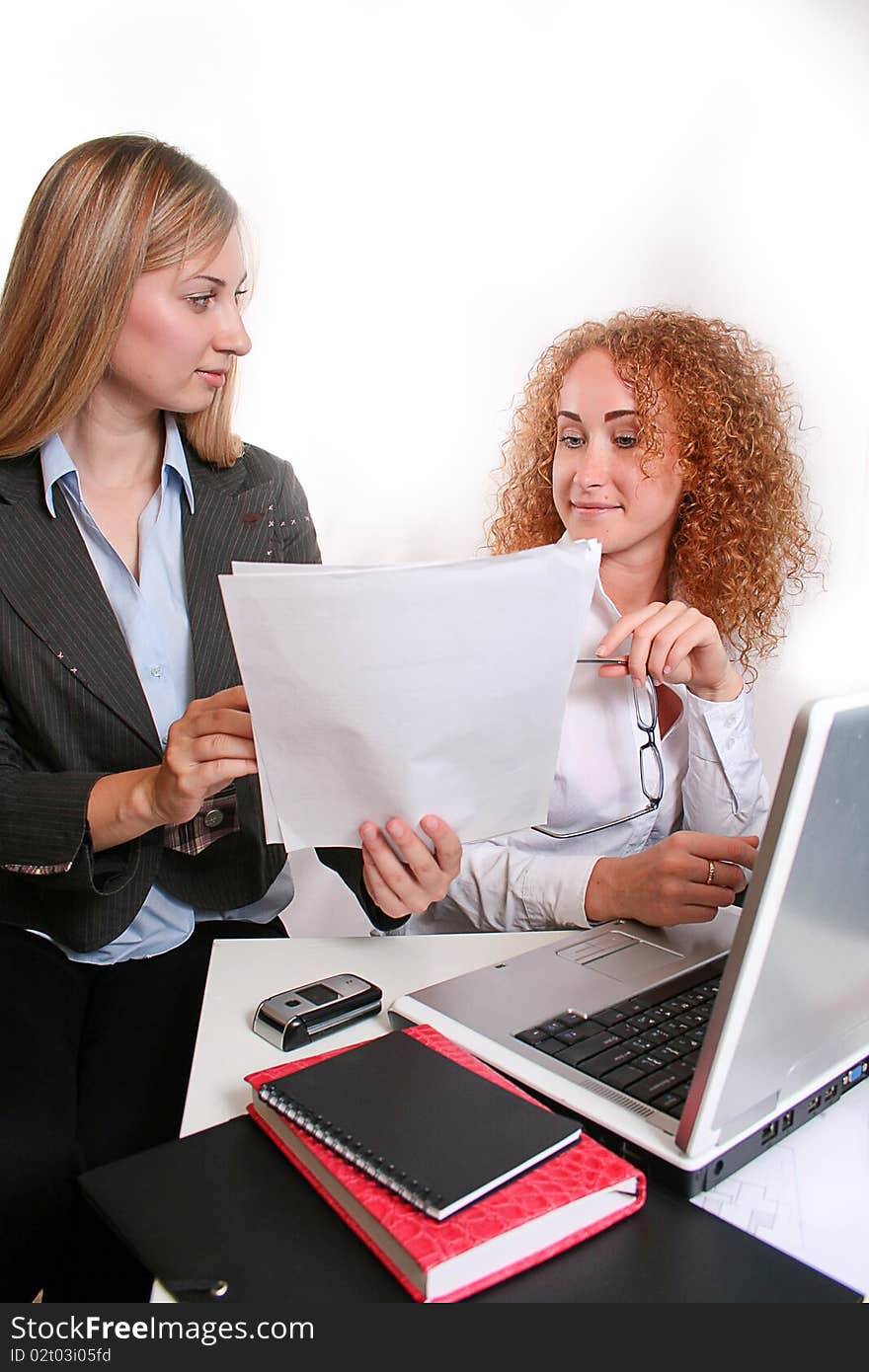 Young smiling business woman working  and consulting a partner. Young smiling business woman working  and consulting a partner