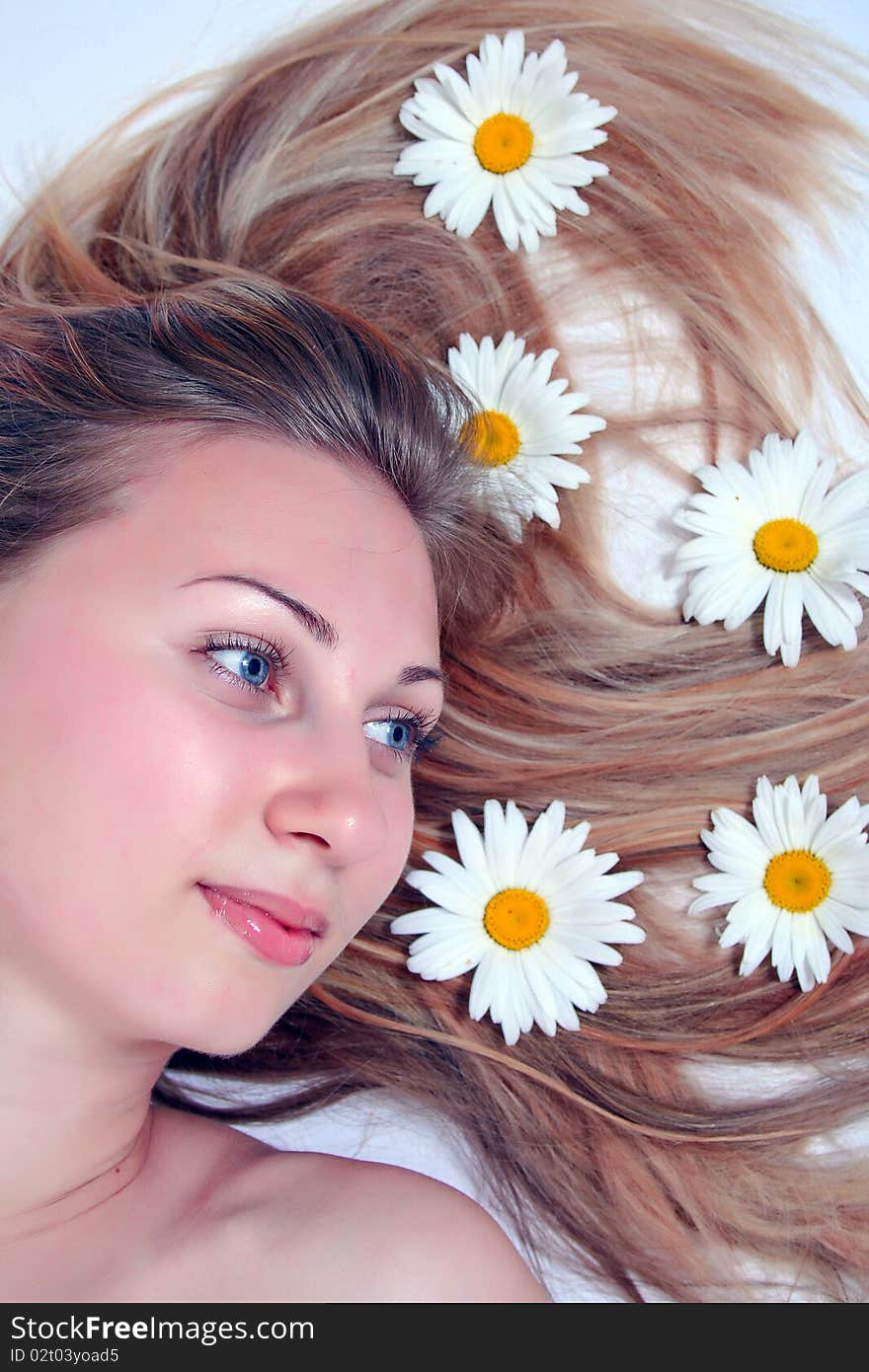 Beautiful woman with chamomile