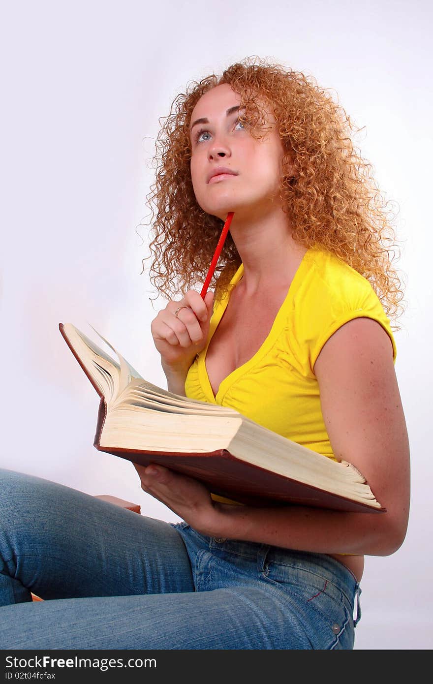 Studying happy young woman reading her book for school. Studying happy young woman reading her book for school