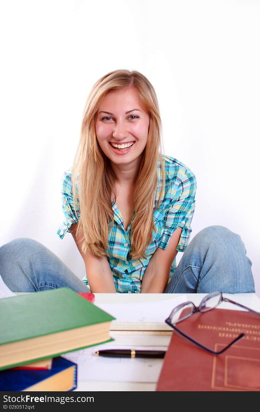 Studying happy young woman reading her book for school. Studying happy young woman reading her book for school.