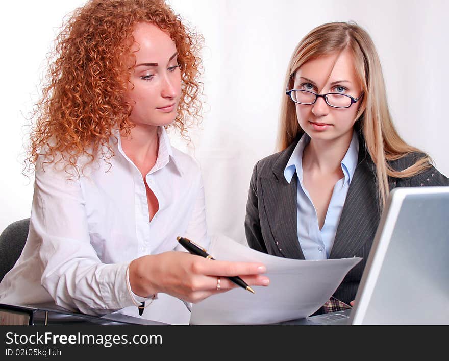 Young smiling business woman working and consulting a partner. Young smiling business woman working and consulting a partner