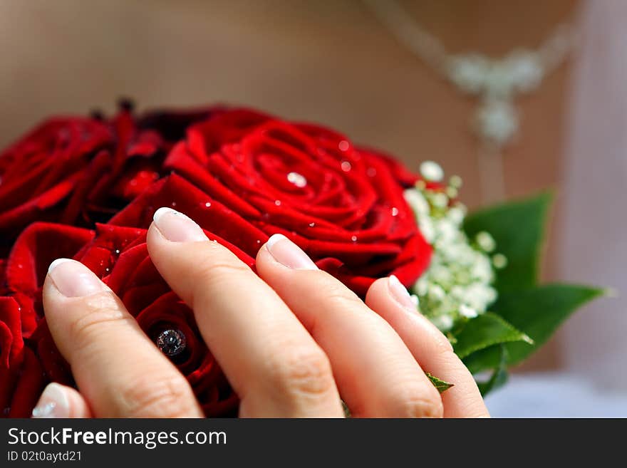 Wedding red flowers bouquet with bride hand. Wedding red flowers bouquet with bride hand