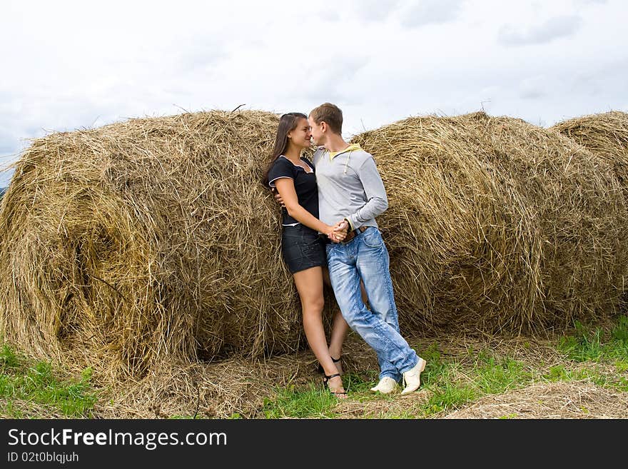 Young couple costs about a haystack