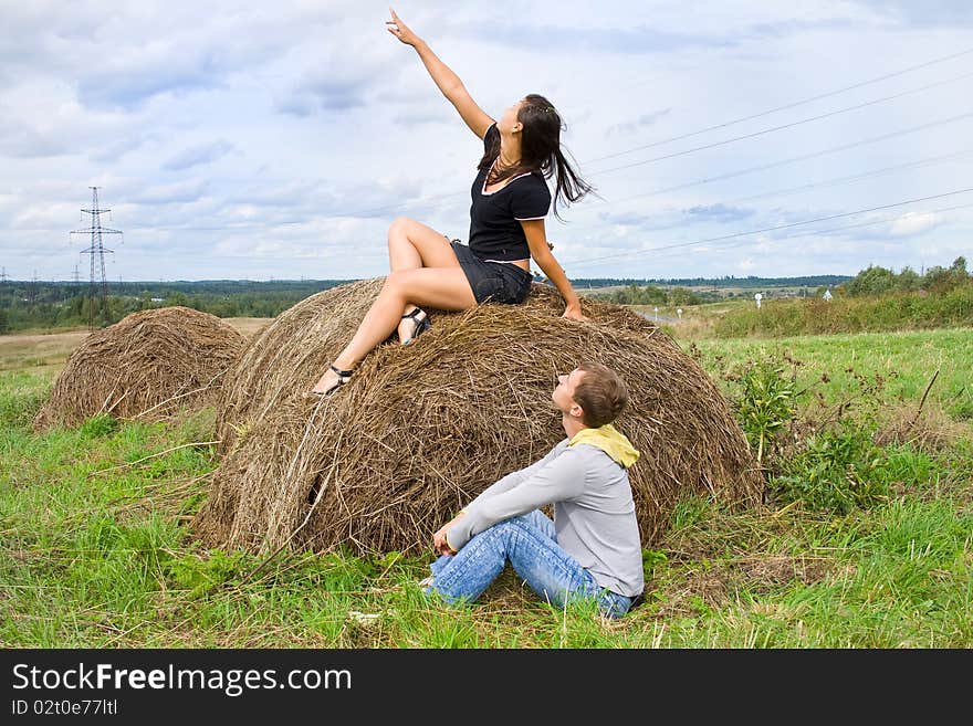 Young couple costs about a haystack