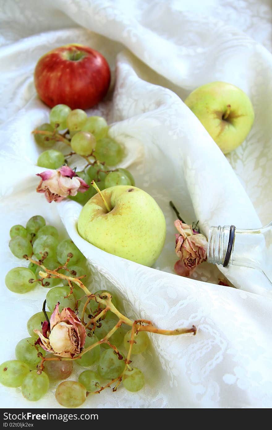 Apples and green grapes on the bed. Apples and green grapes on the bed