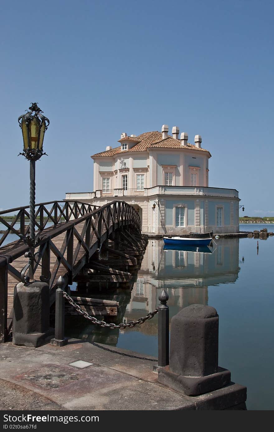 A villa on an island in the middle of a lake. A villa on an island in the middle of a lake