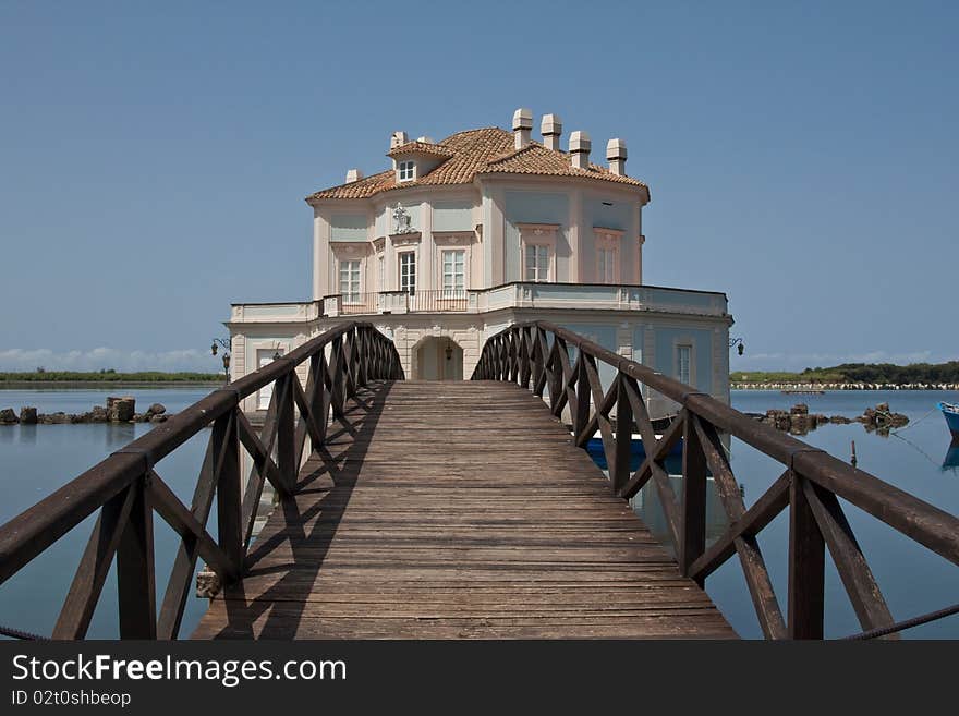 A villa on an island in the middle of a lake. A villa on an island in the middle of a lake