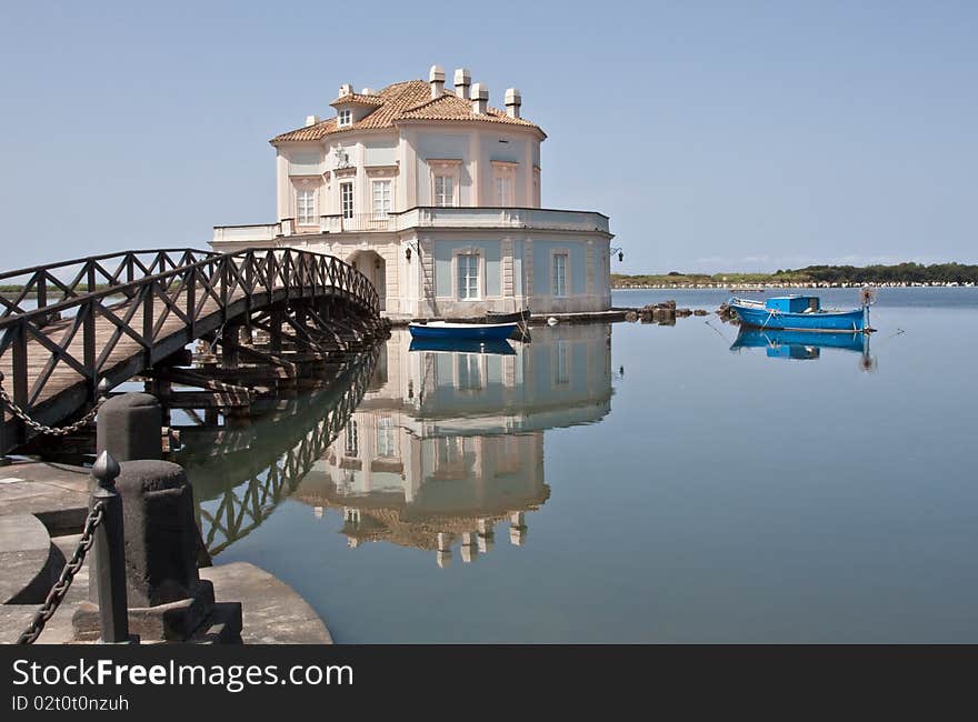 A villa on an island in the middle of a lake. A villa on an island in the middle of a lake