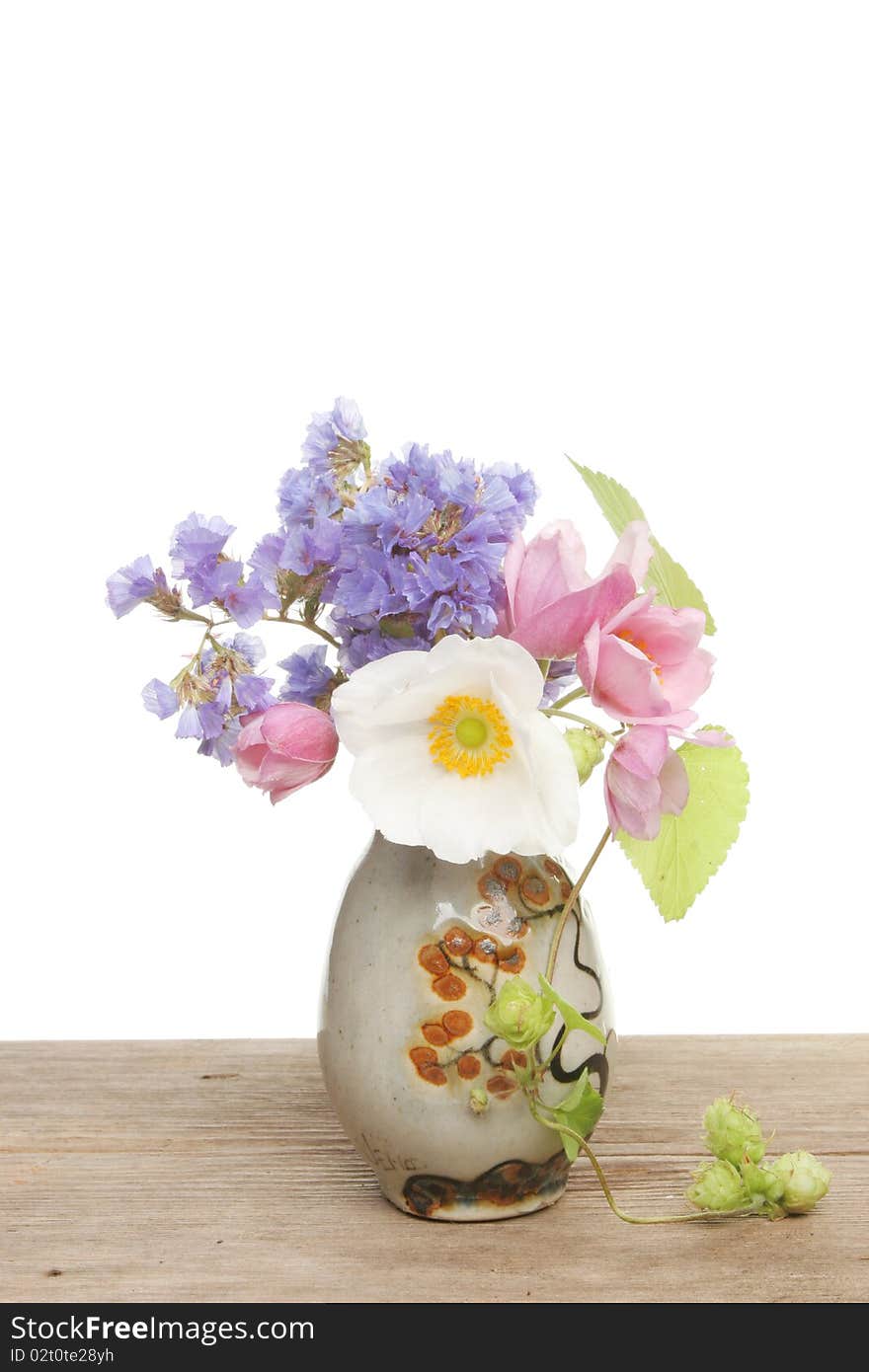 Small flower arrangement in a pottery vase