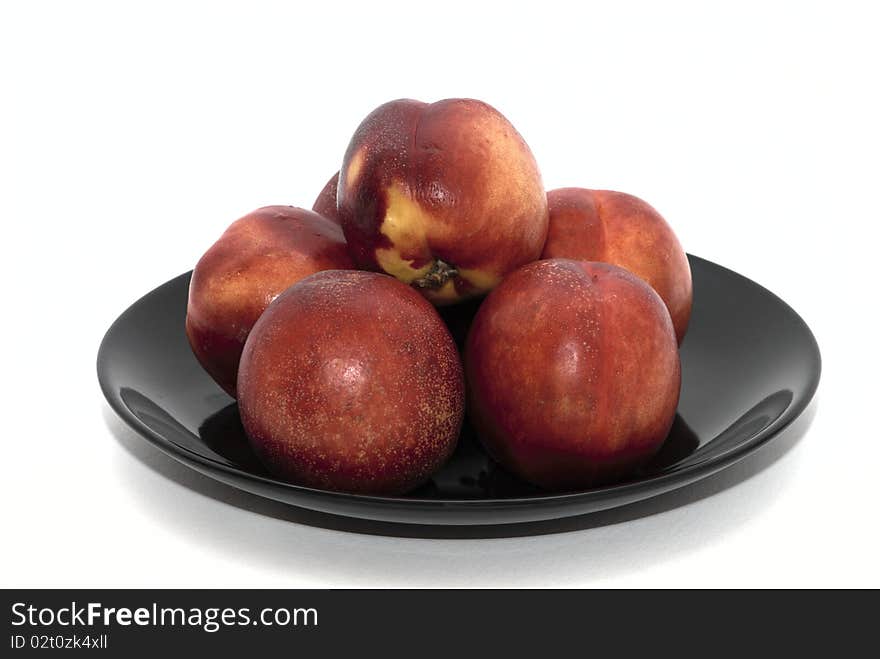 Peaches on the black plate. Peaches on the black plate