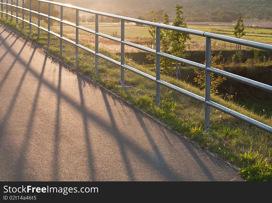 A fence is lighten up by the sun. A fence is lighten up by the sun.