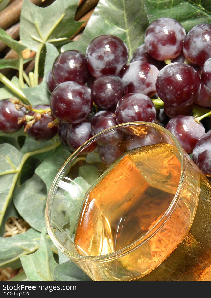 Bunch of grapes and a glass of rose wine. Bunch of grapes and a glass of rose wine