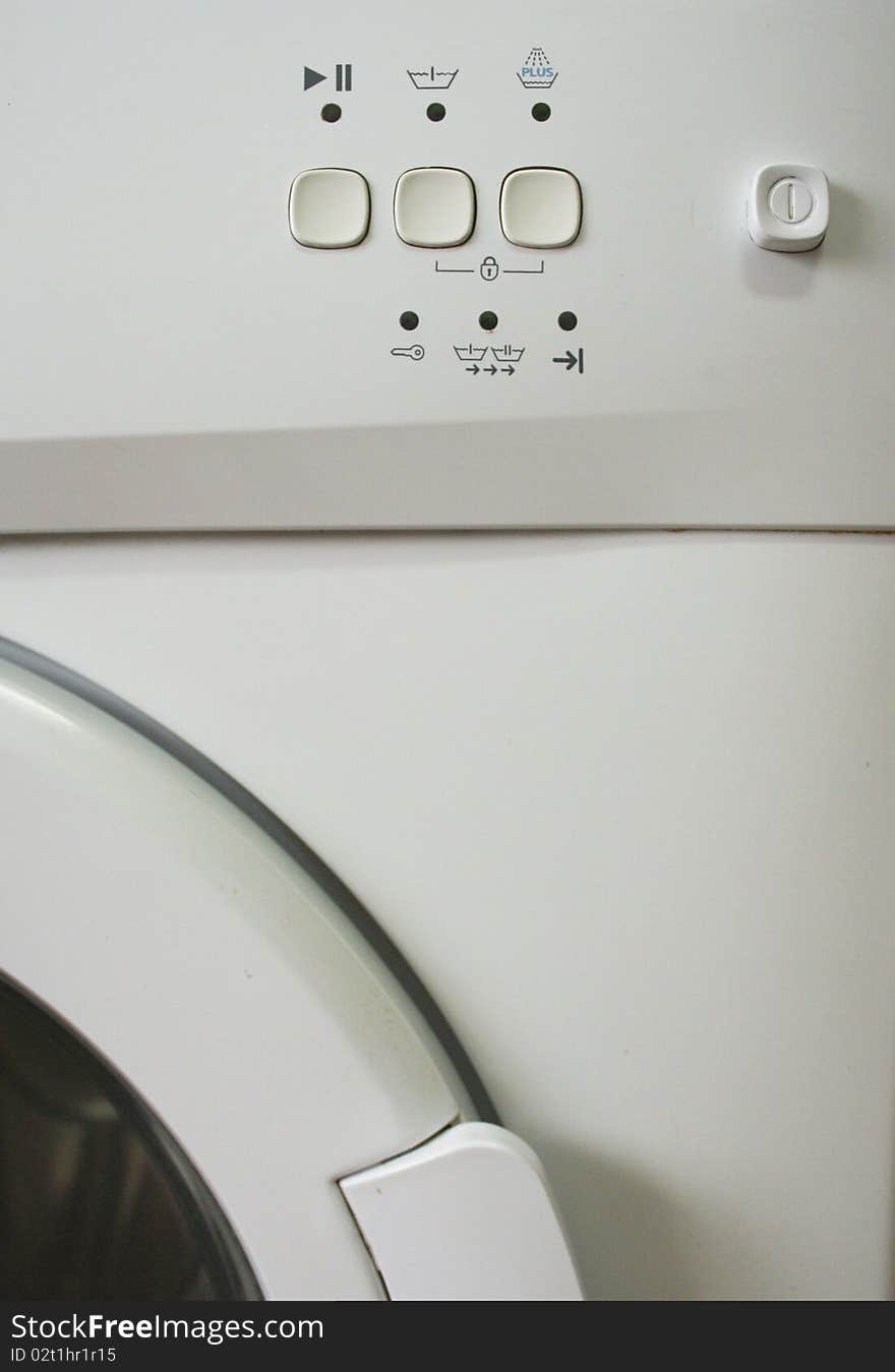 Detail of a washing machine with door and buttons. Detail of a washing machine with door and buttons