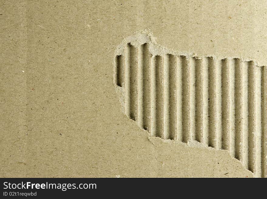 Textured cardboard ripped showing corrugation underneath. Textured cardboard ripped showing corrugation underneath.