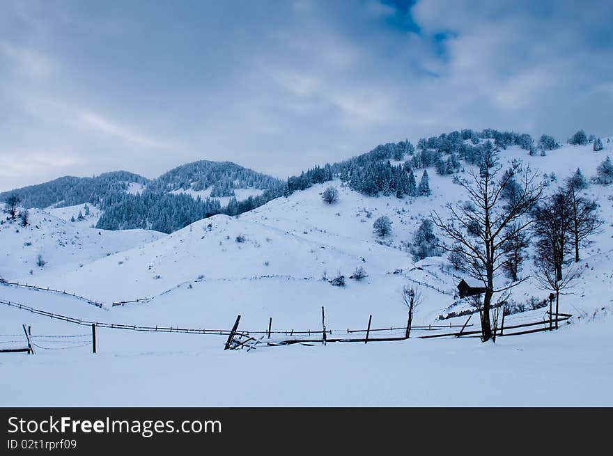 Isolated House in Mountains in Winter Landscape