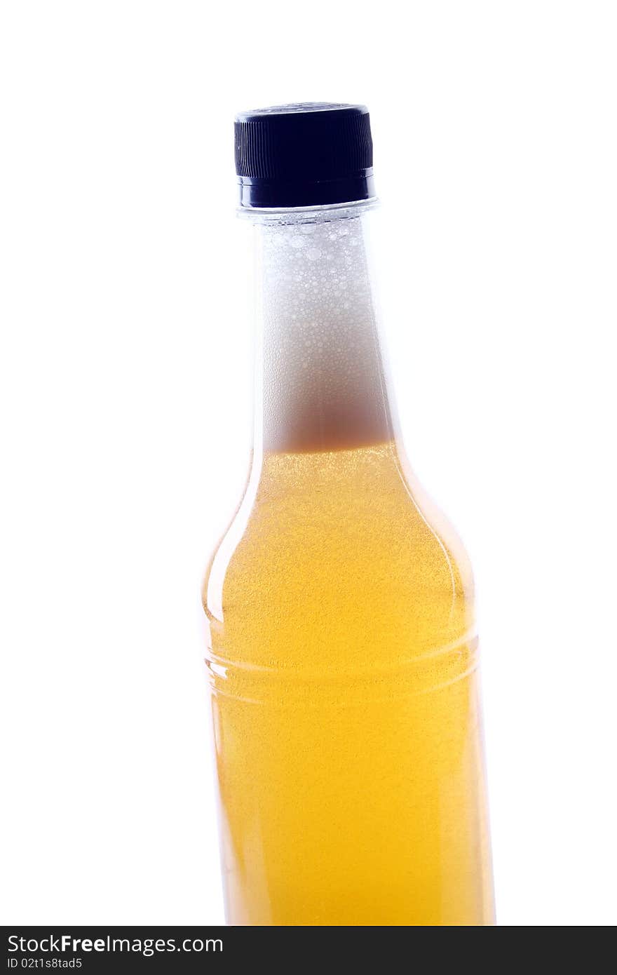 A bottle of beer is slanted with white background