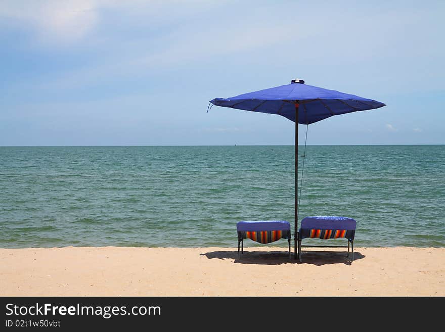 Deckchairs and parasol on the white sand beach facing the beach, Thailand. Deckchairs and parasol on the white sand beach facing the beach, Thailand